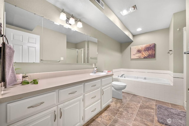 bathroom featuring toilet, vanity, and tiled bath