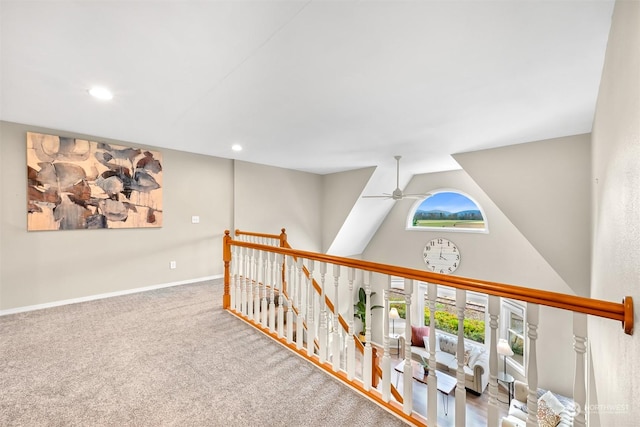 hallway with lofted ceiling and carpet flooring