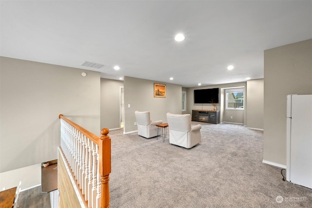 unfurnished living room featuring light carpet