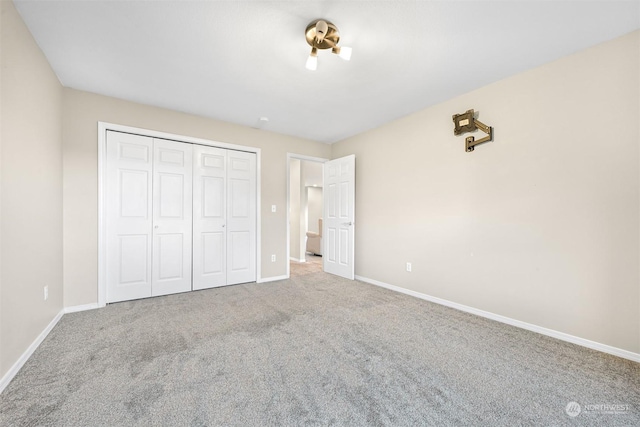 unfurnished bedroom featuring carpet floors and a closet