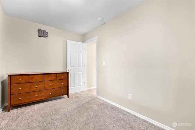 unfurnished bedroom featuring light colored carpet