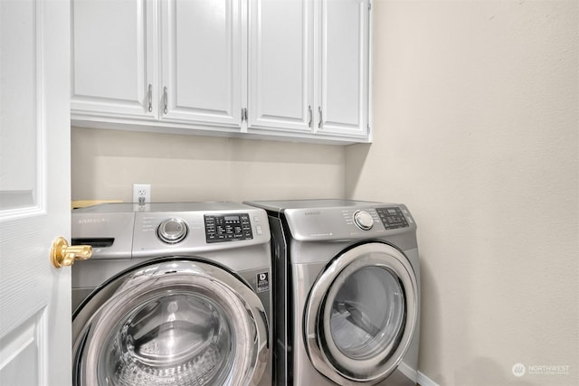 washroom featuring cabinets and separate washer and dryer