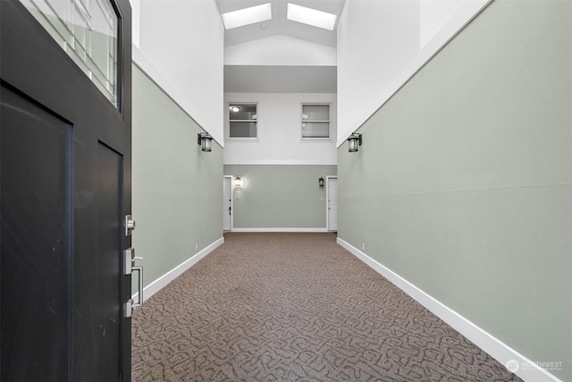 interior space with a skylight and high vaulted ceiling