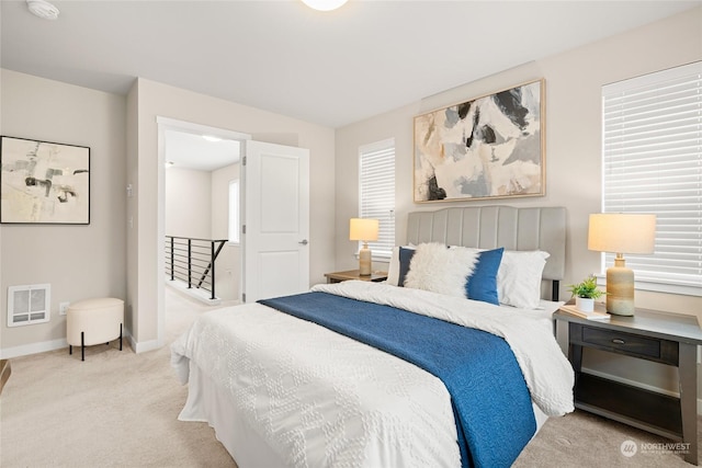 carpeted bedroom with multiple windows