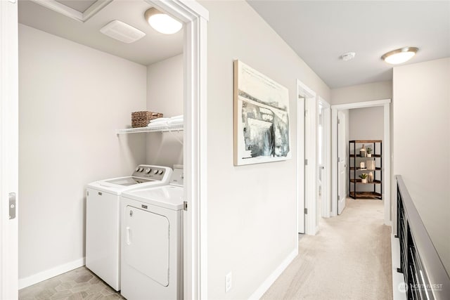 washroom featuring washer and dryer and light carpet