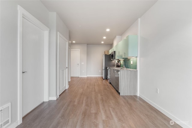 hallway with light hardwood / wood-style flooring