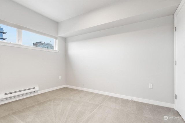 carpeted empty room with a baseboard heating unit