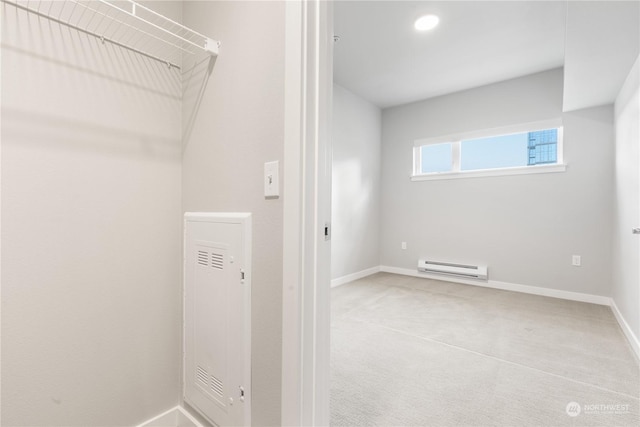 clothes washing area featuring carpet floors and a baseboard radiator