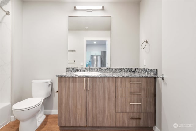 full bathroom featuring vanity, toilet, bathing tub / shower combination, and wood-type flooring