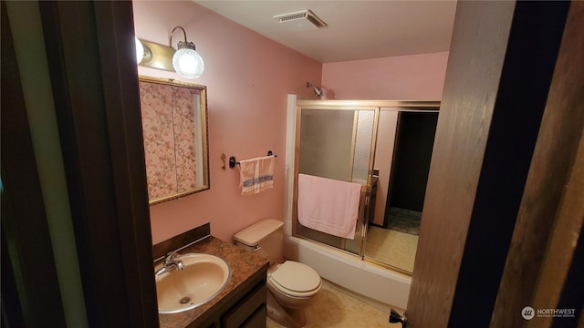 full bathroom with vanity, combined bath / shower with glass door, and toilet