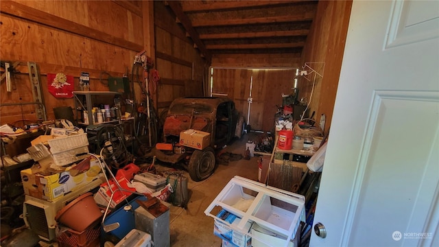 miscellaneous room with lofted ceiling and wooden walls