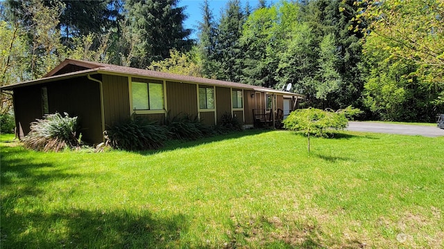 view of side of home with a lawn