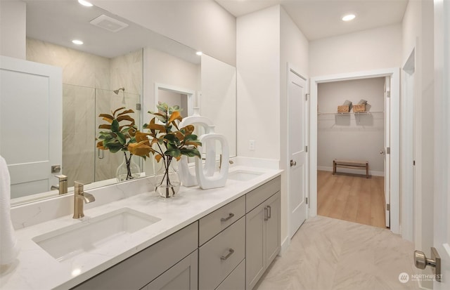 bathroom featuring vanity and an enclosed shower