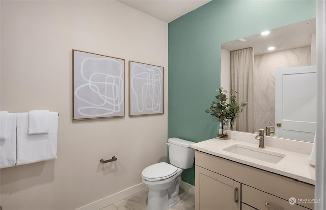 bathroom with vanity and toilet