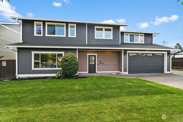 view of front of property with a garage and a front yard