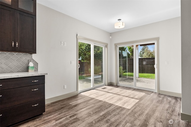 unfurnished dining area featuring light hardwood / wood-style flooring and a healthy amount of sunlight