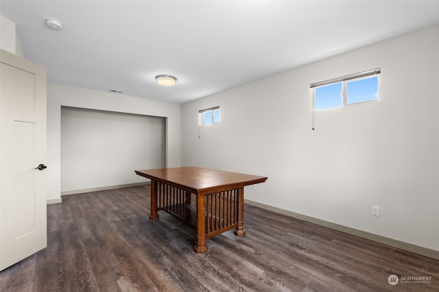 unfurnished office featuring dark hardwood / wood-style flooring