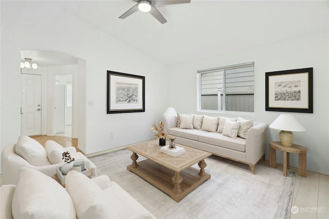 living room with ceiling fan, lofted ceiling, and light hardwood / wood-style flooring