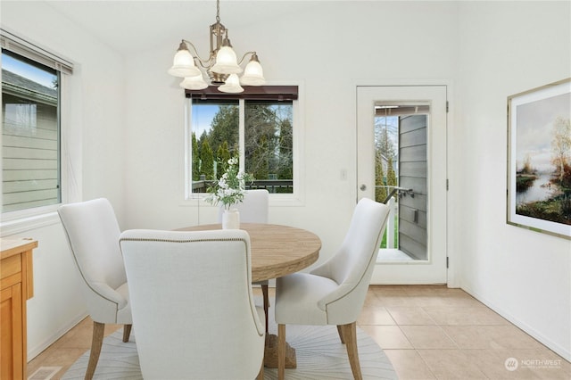 tiled dining space featuring plenty of natural light and a notable chandelier