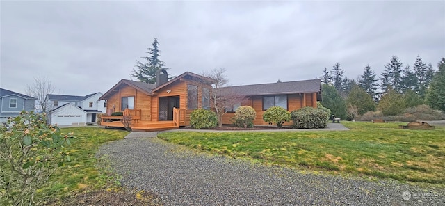 view of front of home with a front yard and a deck