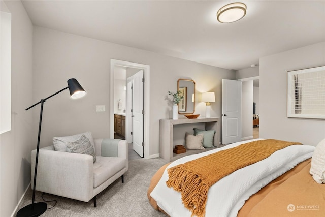 bedroom with light colored carpet and ensuite bathroom