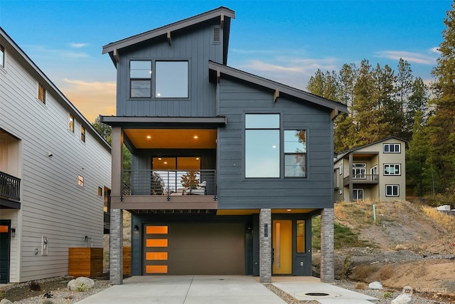 contemporary home featuring a balcony and a garage