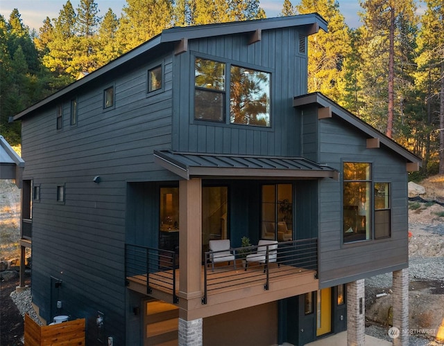 rear view of property featuring a balcony