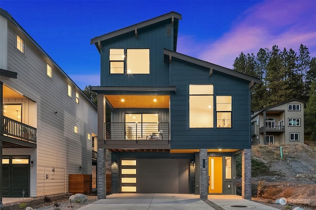 contemporary house with a garage and a balcony