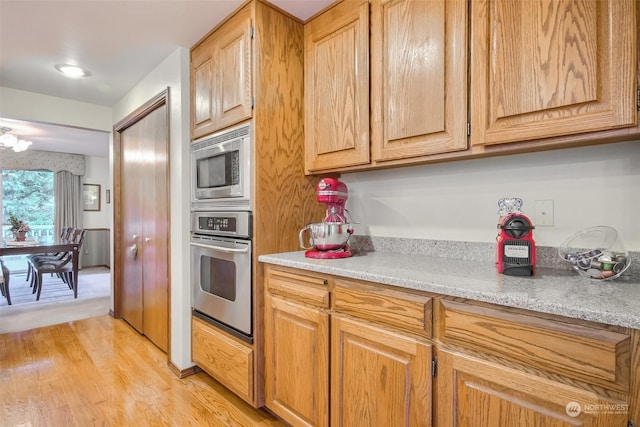 kitchen with light hardwood / wood-style flooring and stainless steel appliances