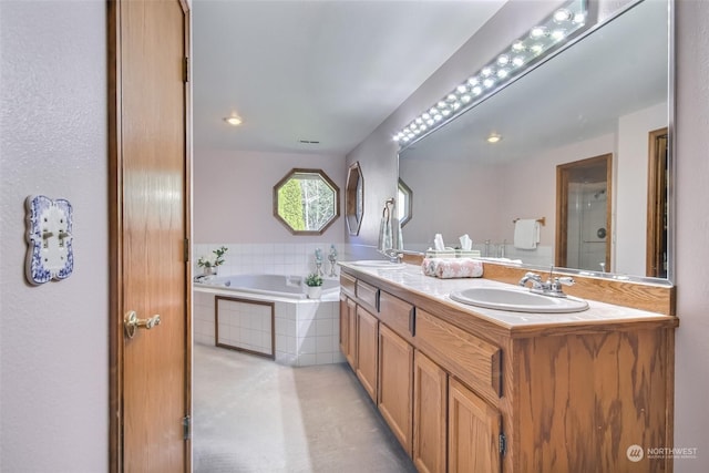 bathroom with vanity and shower with separate bathtub