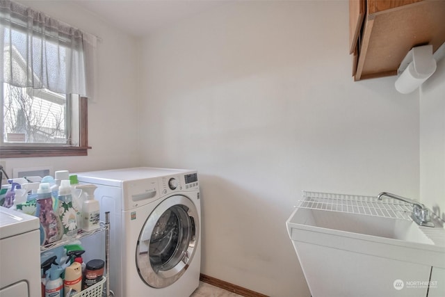 laundry area featuring cabinets, sink, and independent washer and dryer