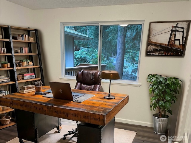 home office with baseboards and wood finished floors