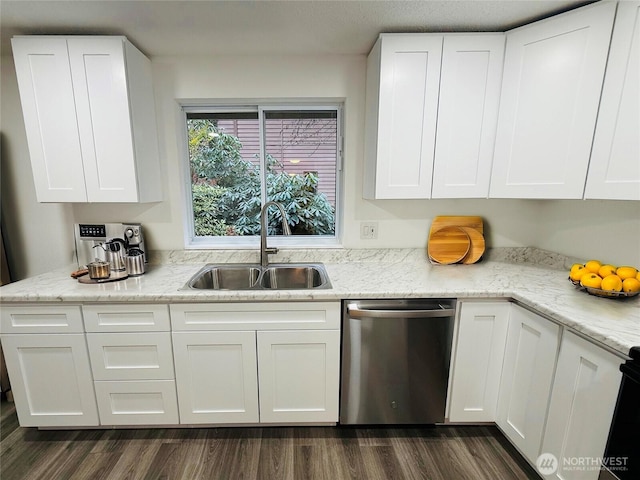 kitchen with white cabinets, dark wood-type flooring, light stone countertops, stainless steel dishwasher, and a sink