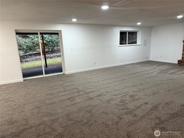 empty room with recessed lighting, dark carpet, and baseboards