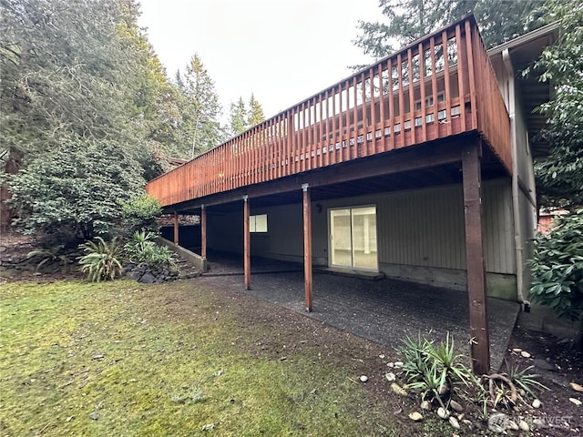 view of property exterior featuring a yard and a wooden deck