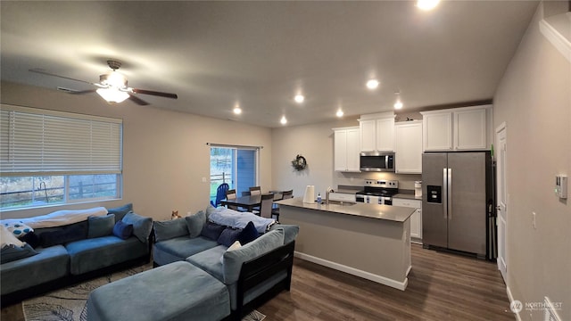 living room with sink, dark wood-type flooring, and ceiling fan