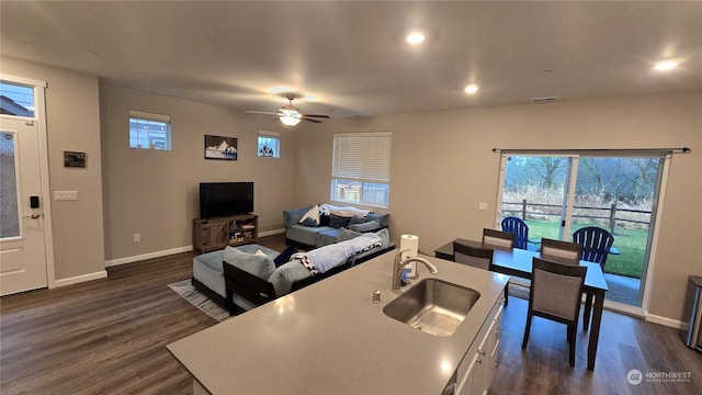 kitchen featuring visible vents, baseboards, dark wood-style floors, a sink, and recessed lighting