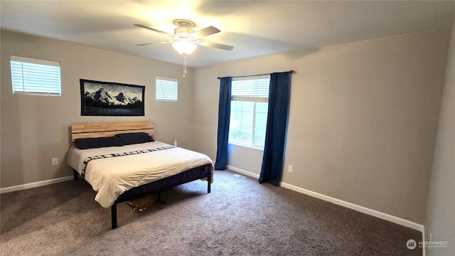 carpeted bedroom with a ceiling fan and baseboards