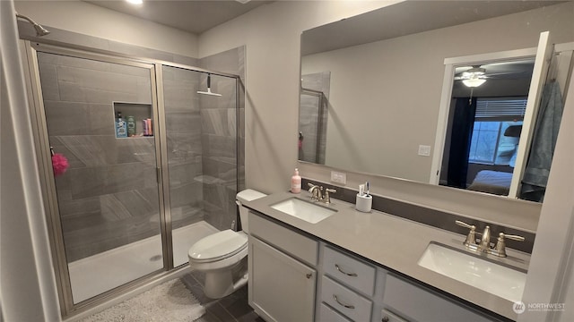 bathroom with toilet, a stall shower, and a sink