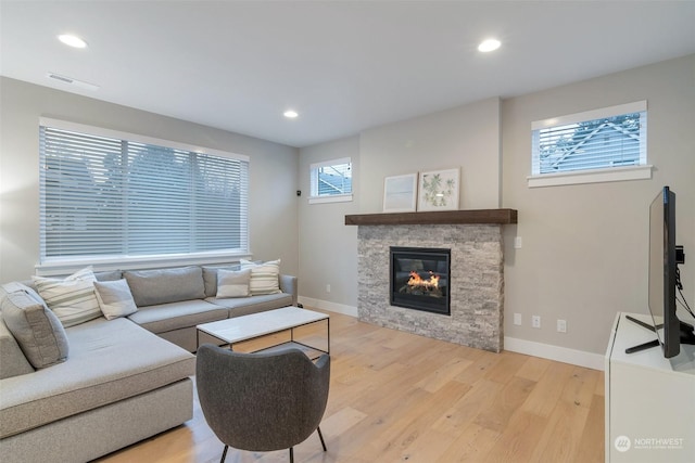 living room with a fireplace and light hardwood / wood-style flooring