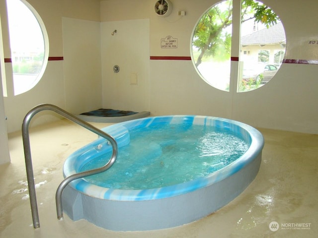 view of pool with an indoor hot tub