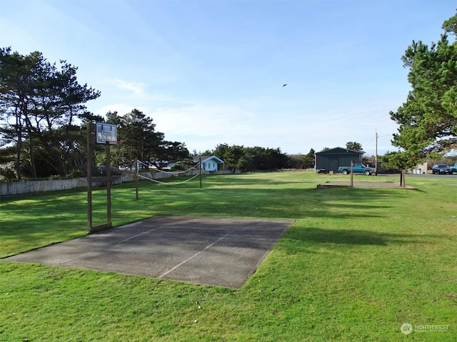 view of basketball court featuring a yard