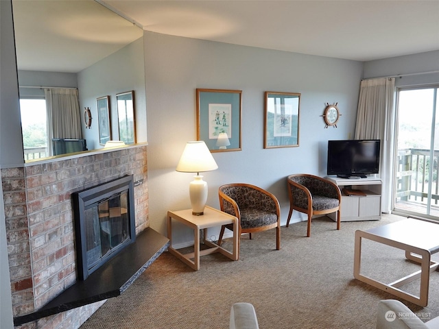 carpeted living room with a wealth of natural light and a fireplace