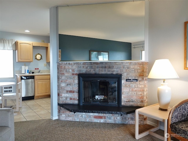 living room with sink, light colored carpet, and a fireplace