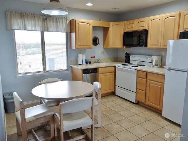 kitchen with white appliances, light brown cabinetry, sink, and light tile patterned floors