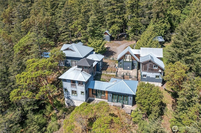birds eye view of property with a wooded view