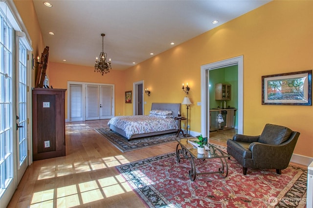 bedroom with recessed lighting, a chandelier, baseboards, and wood finished floors