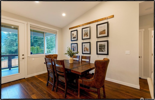 dining room with lofted ceiling and dark wood-type flooring