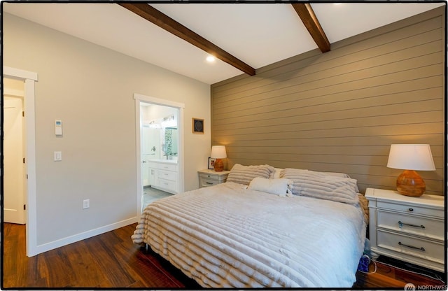 bedroom with connected bathroom, dark hardwood / wood-style floors, wooden walls, and beam ceiling