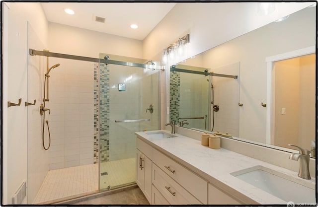 bathroom with vanity and a shower with door